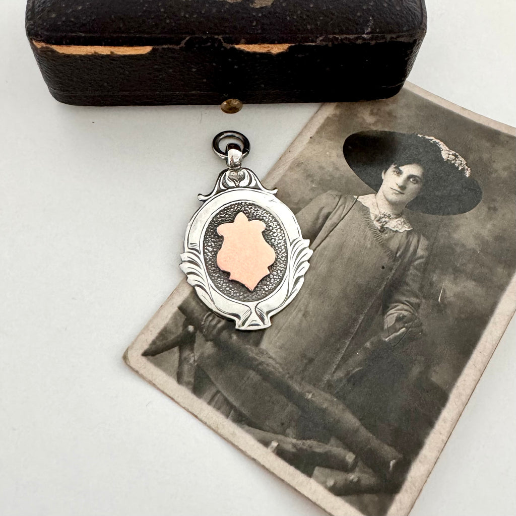 Silver and rose gold 1933 watch fob pendant with an old jewellery box and photograph of a woman.