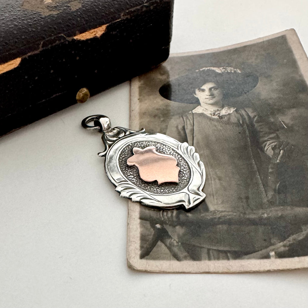 Silver and rose gold 1933 watch fob pendant with an old photograph of a woman.