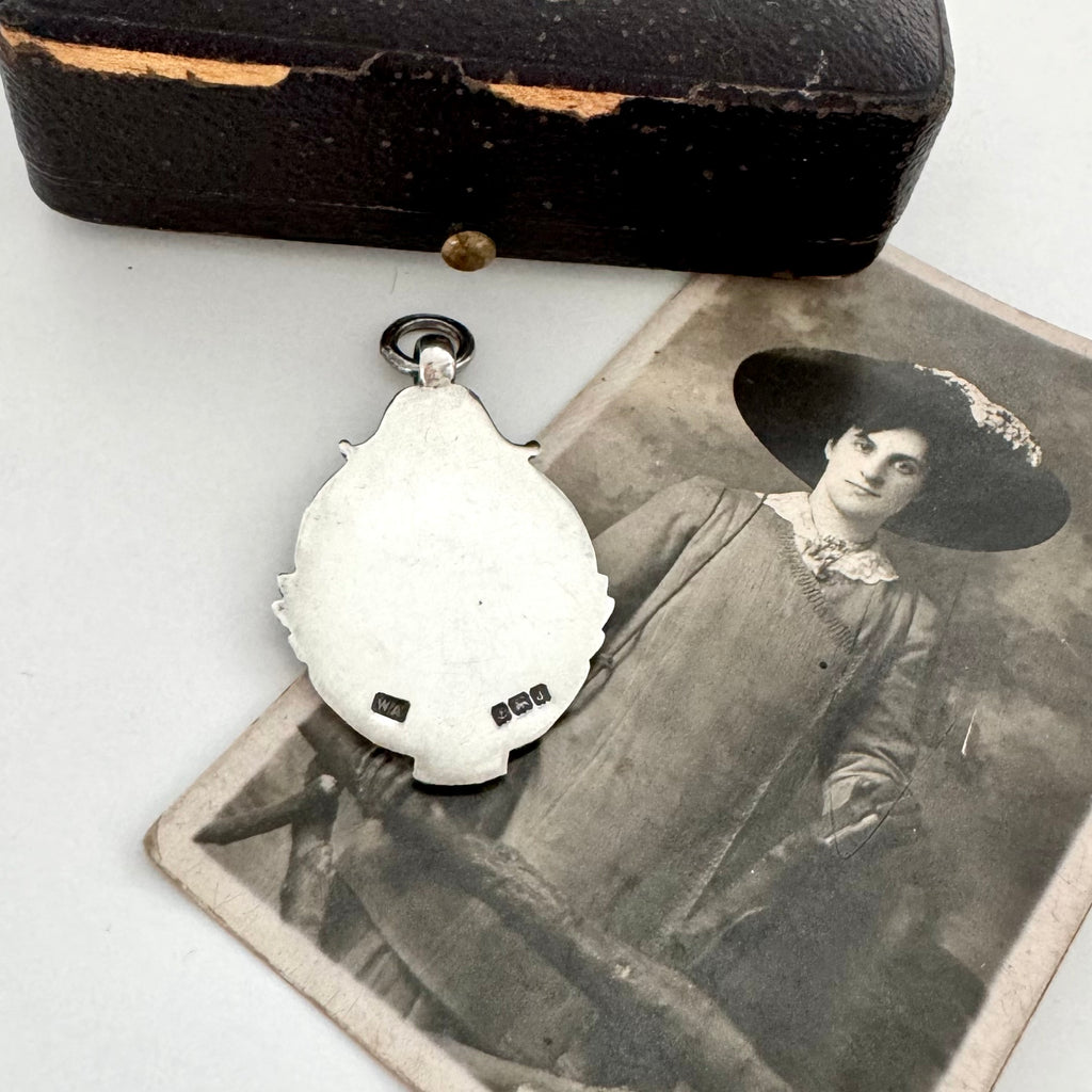 Back of silver and rose gold 1933 watch fob pendant with an old photograph of a woman.