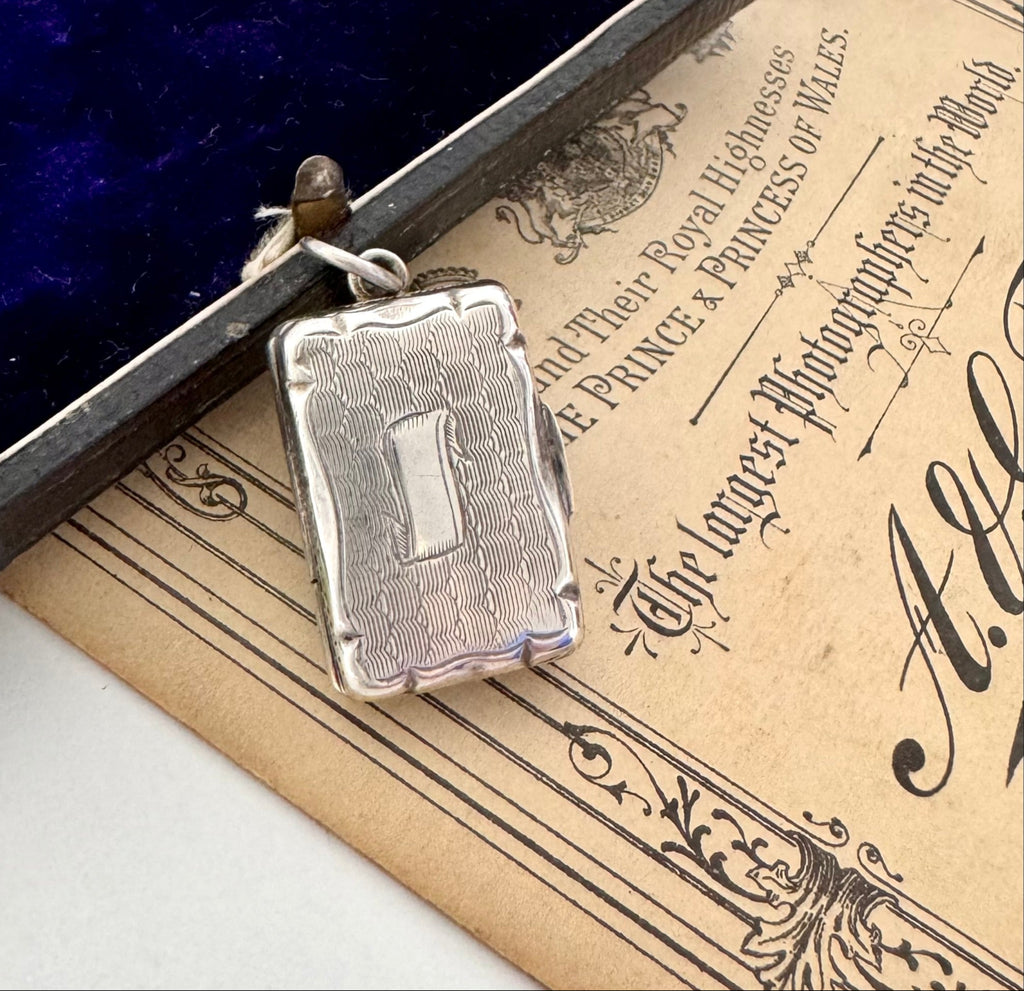 Antique 1864 sterling silver vinaigrette on an antique advertising for a photographer's studio and a vintage jewellery box