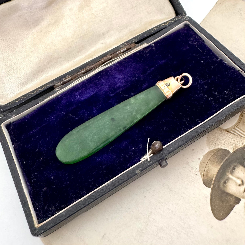 Antique 9ct rose gold and greenstone pendant in an open vintage jewellery box