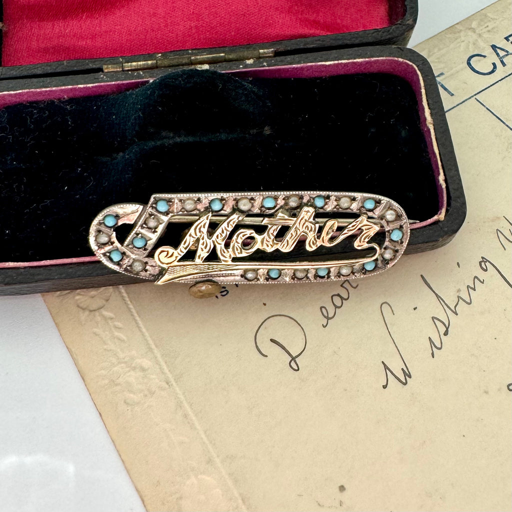 Edwardian 9ct gold silver lined 'Mother' brooch with turquoise and seed pearls in a black case with red interior on an old letter background