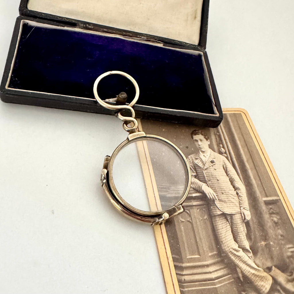 Antique Carpenter & Westley 9ct gold glasses in a box with an old photograph of a man in formal attire.