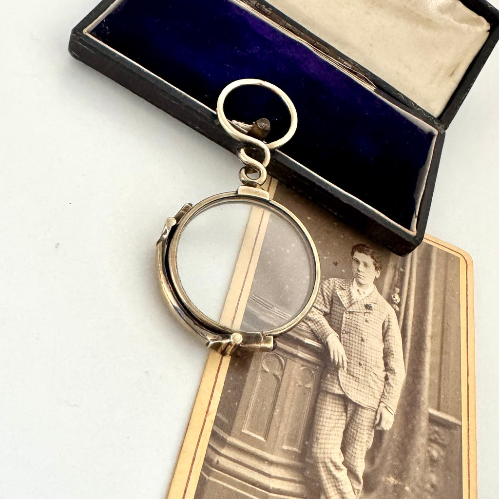 Antique Carpenter & Westley 9ct gold glasses in a box with an old photograph of a man in formal attire.