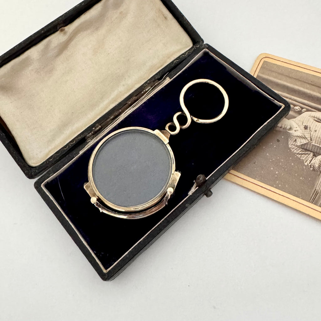 Antique Carpenter & Westley 9ct gold glasses in a box with an old photograph of a man in formal attire.