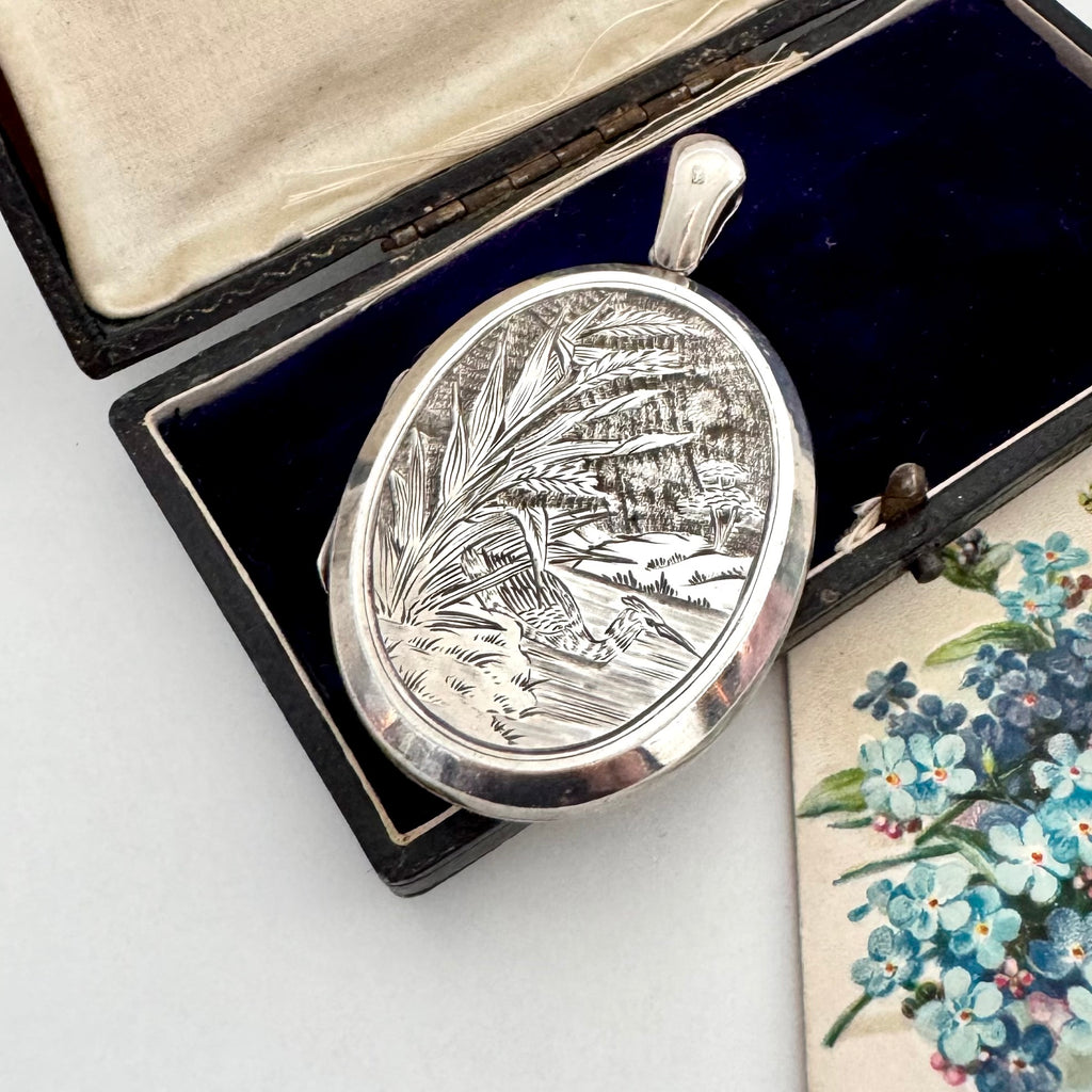 Antique 1879 sterling silver locket with engraved design in a box with floral card