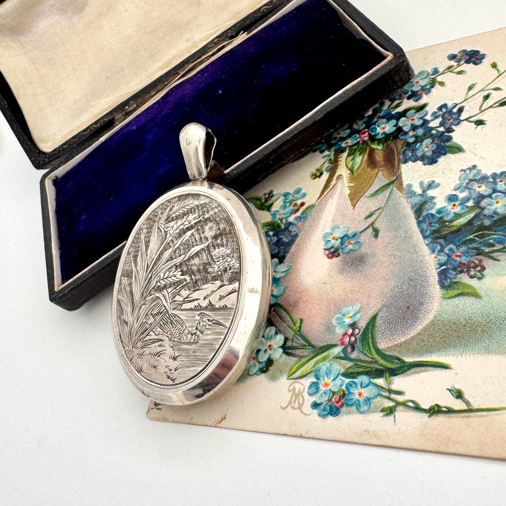 Antique 1879 sterling silver locket with engraved design in a box with floral card