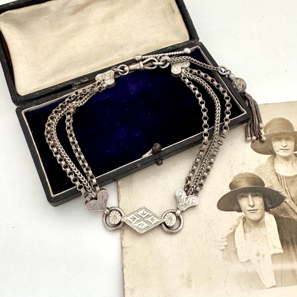 Antique Victorian continental silver triple strand Albertina watch chain with tassel on an old photograph