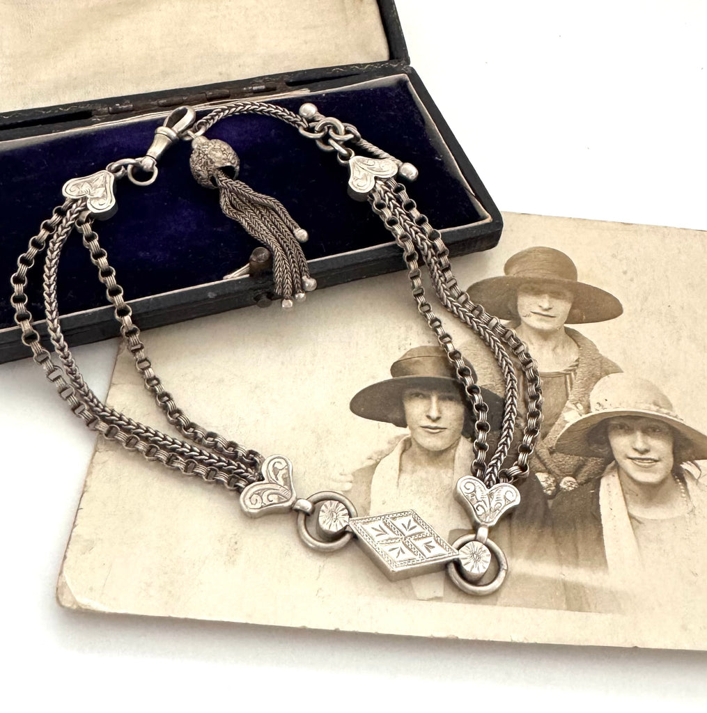 Antique Victorian continental silver triple strand Albertina watch chain with tassel on an old photograph