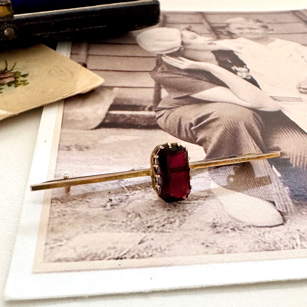 Vonk jewellery red paste stone 9ct gold bar brooch on a vintage photo and postcard