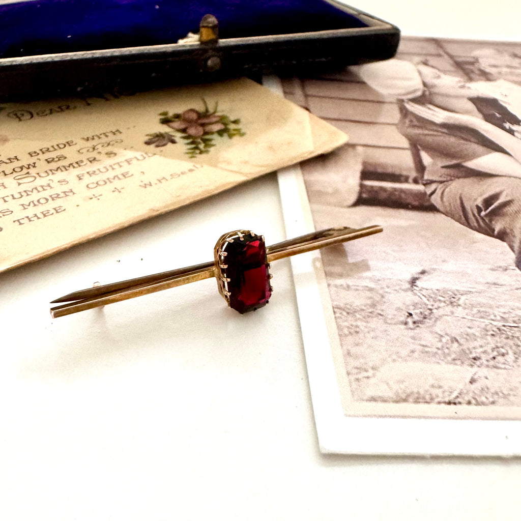 Vonk jewellery red paste stone 9ct gold bar brooch on a vintage photo and postcard