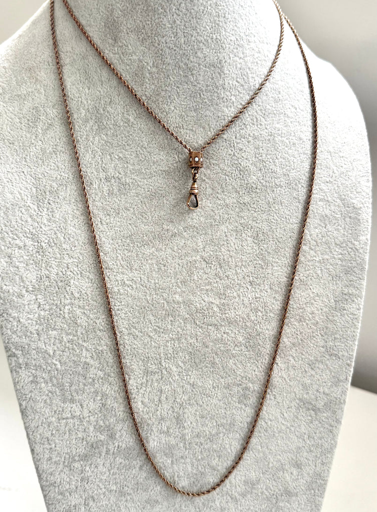 Antique A.H.B & C rolled rose gold guard chain with opal slider on agrey mannequin