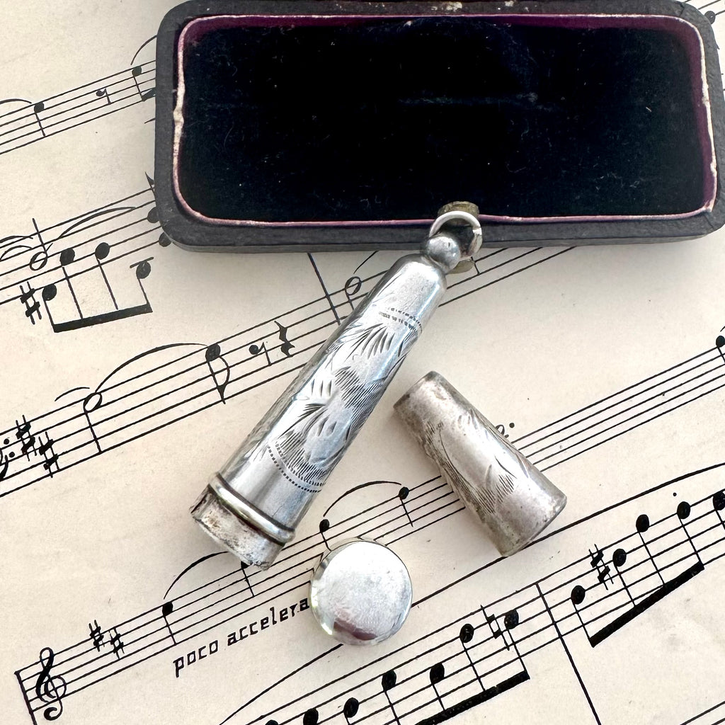Antique silver cheroot holder case on old sheet music and with a jewellery box