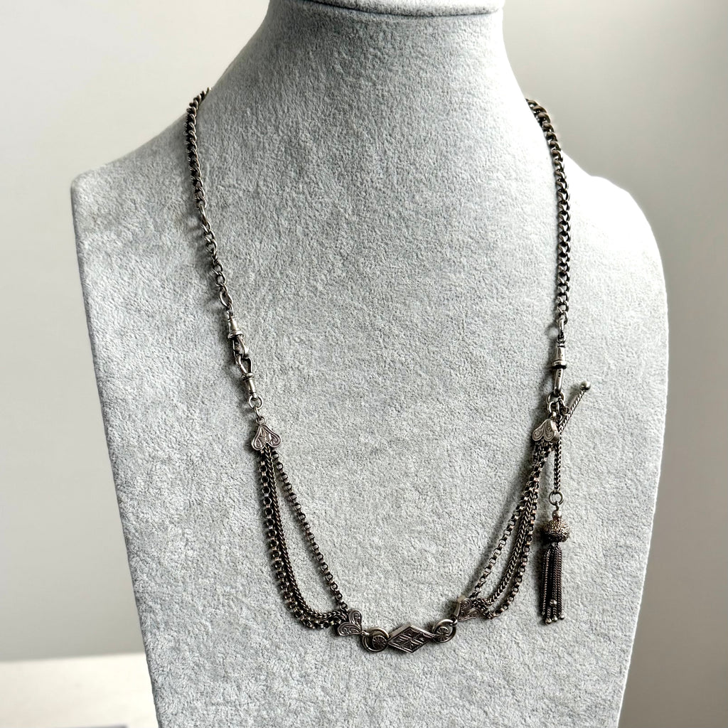 Antique Victorian continental silver triple strand Albertina watch chain with tassel on a grey mannequin