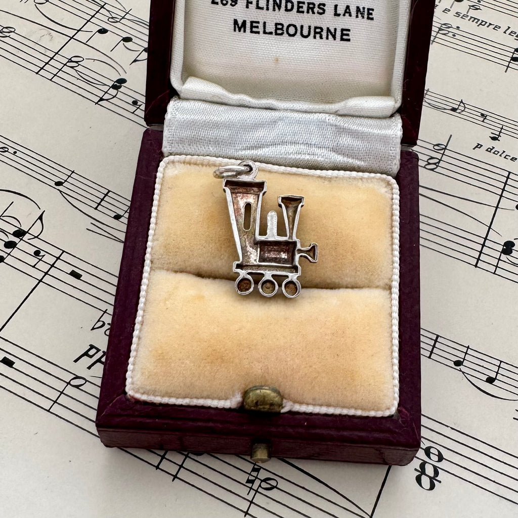 Silver pendant in a jewelry box on sheet music