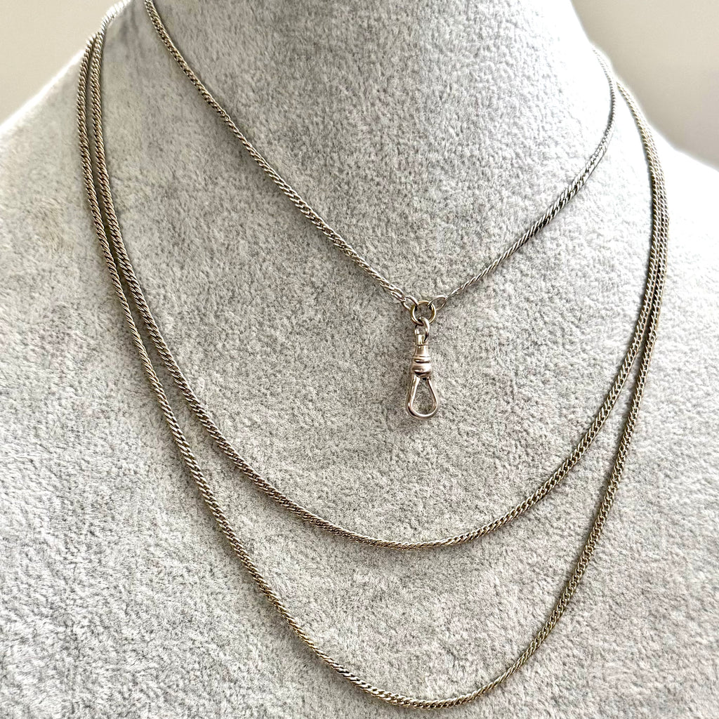 Antique silver guard chain necklace on a grey mannequin