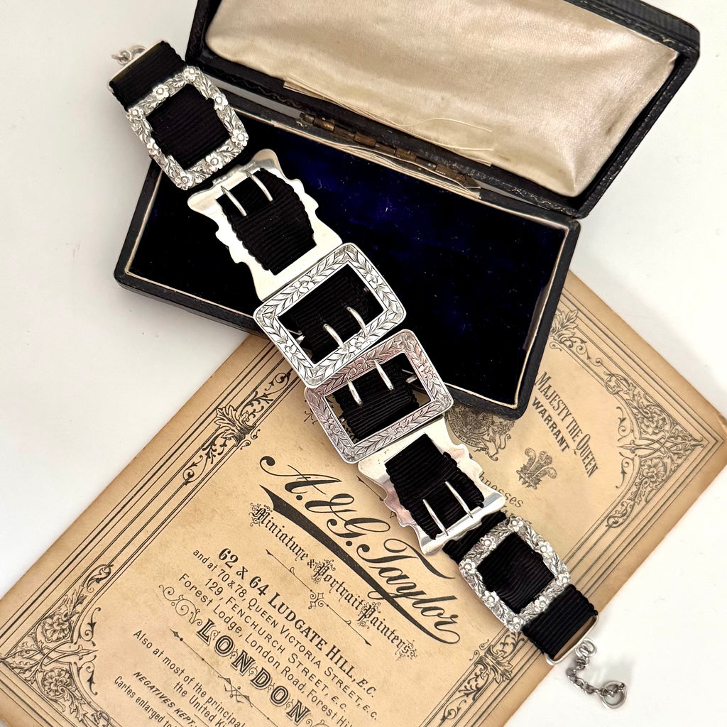 Antique sterling silver buckle bracelet on a vintage box on an old paper background