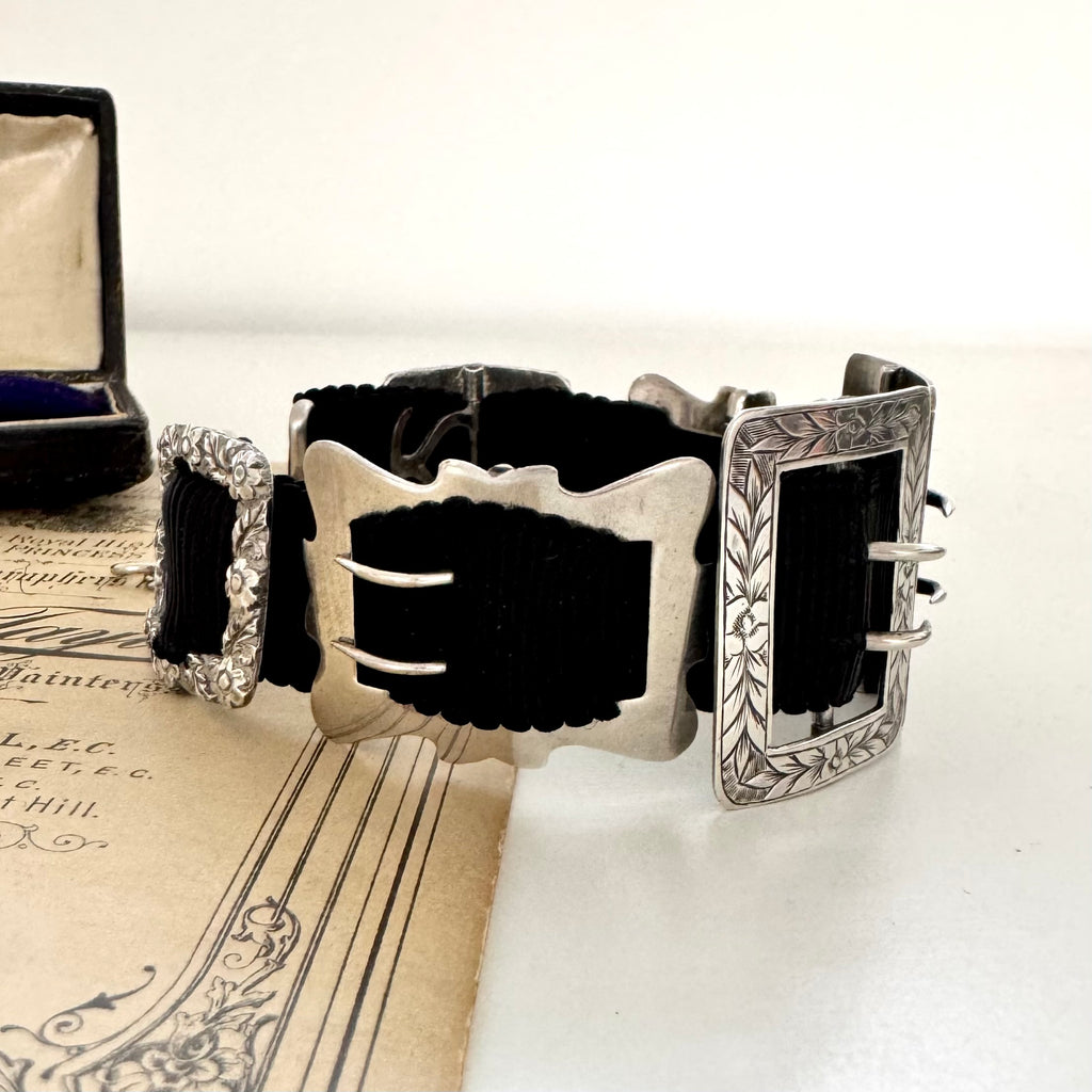 Antique sterling silver buckle bracelet on a vintage box on an old paper background