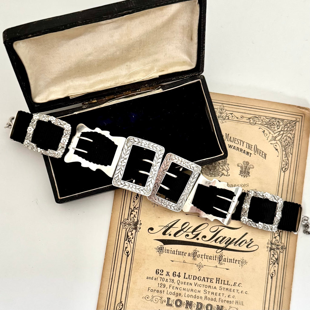 Antique sterling silver buckle bracelet on a vintage box on an old paper background