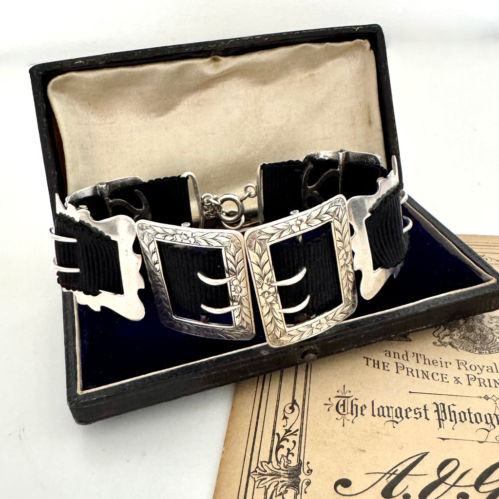 Antique sterling silver buckle bracelet on a vintage box on an old paper background
