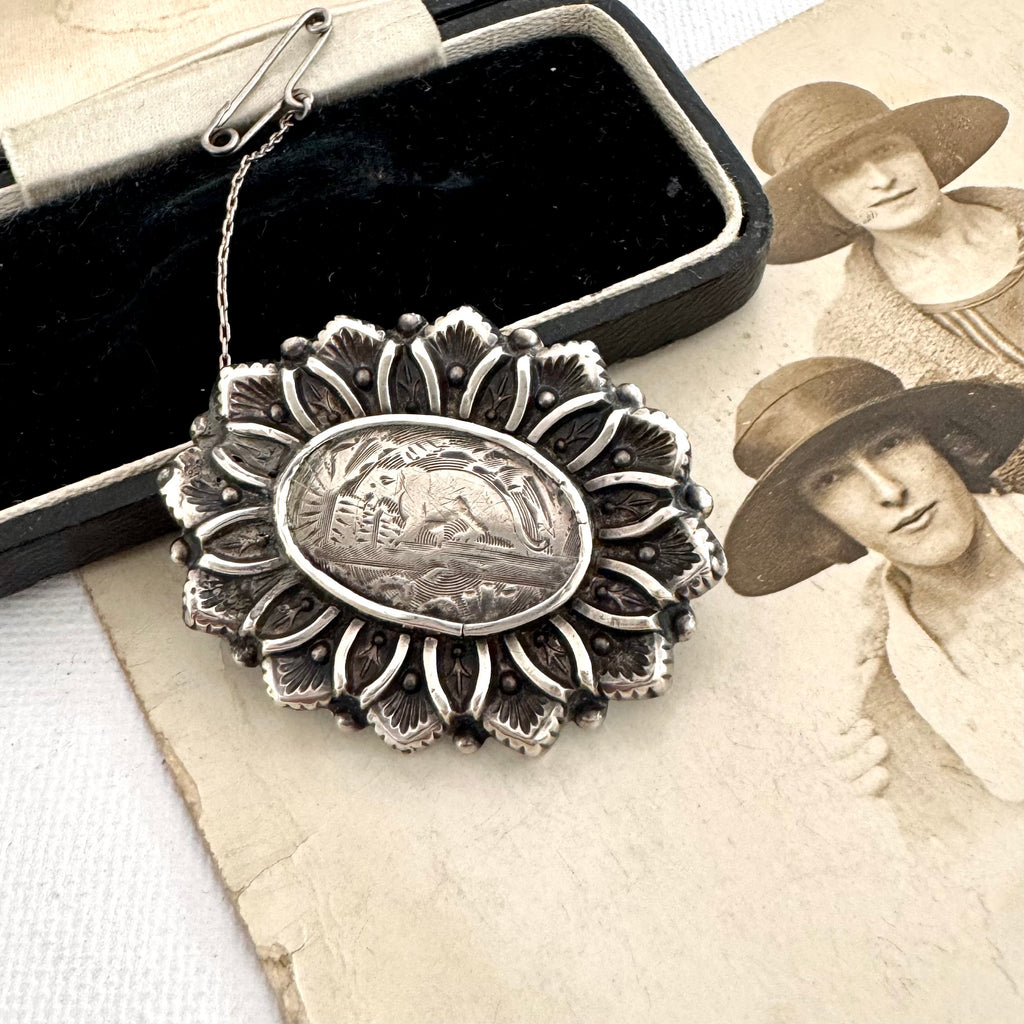 Rare Victorian Aesthetic Era hallmarked 1883 sterling silver brooch with otter or beaver engraving on an old photo and with an old jewellery box.