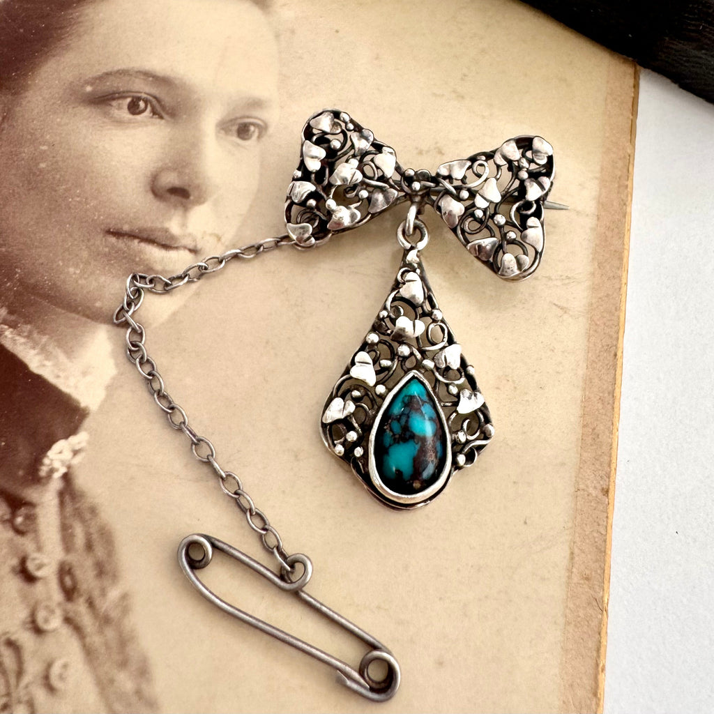 Vonk Jewellery silver arts and crafts bow brooch with turquoise drop on an antique photo of a woman