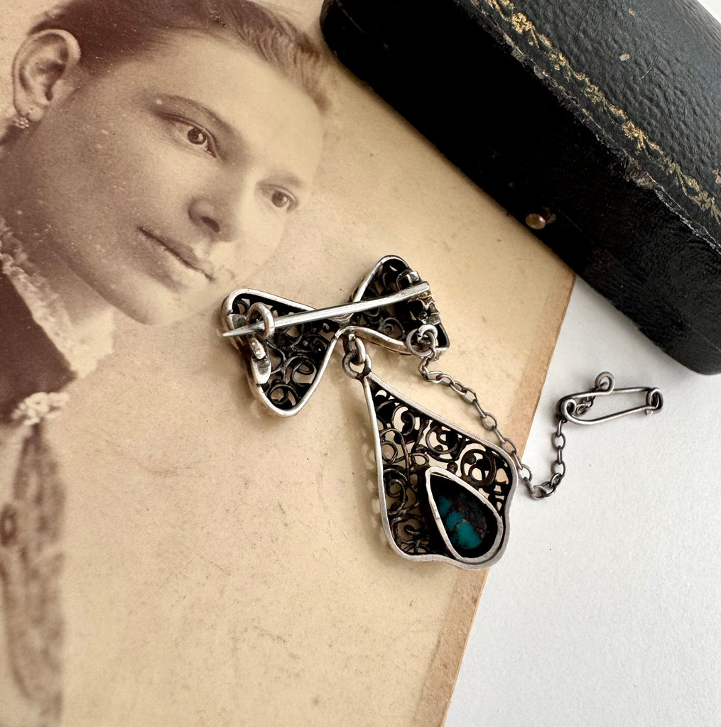 Vonk Jewellery silver arts and crafts bow brooch with turquoise drop on an antique photo of a woman