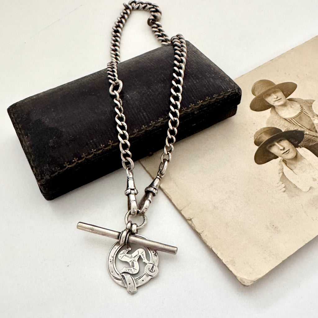Edwardian sterling silver Albert watch chain with Isle Of Man Triskelion fob and edwardian T bar on an old photo with an old jewellery box