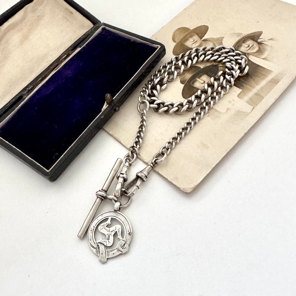 Edwardian sterling silver Albert watch chain with Isle Of Man Triskelion fob and edwardian T bar on an old photo with an old jewellery box