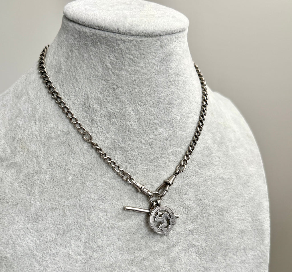 Edwardian sterling silver Albert watch chain with Isle Of Man Triskelion fob and edwardian T bar on a grey mannequin