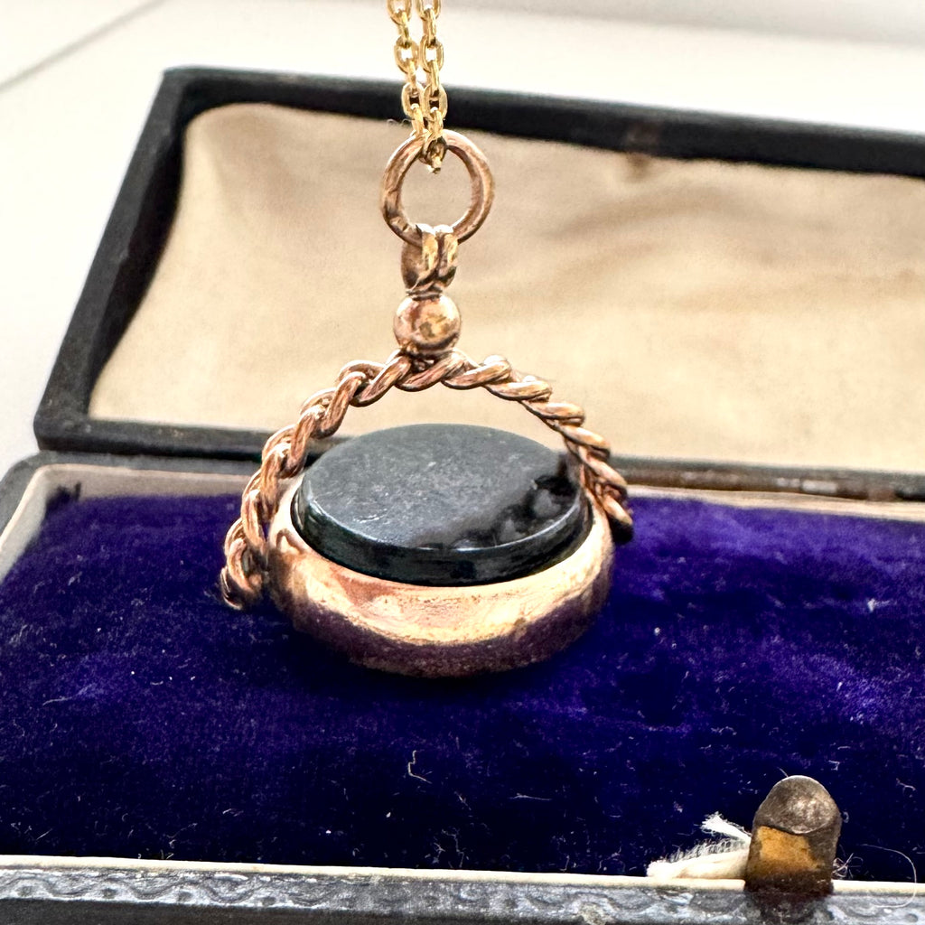 Antique rolled gold carnelian and bloodstone spinning fob on a vintage jewellery box