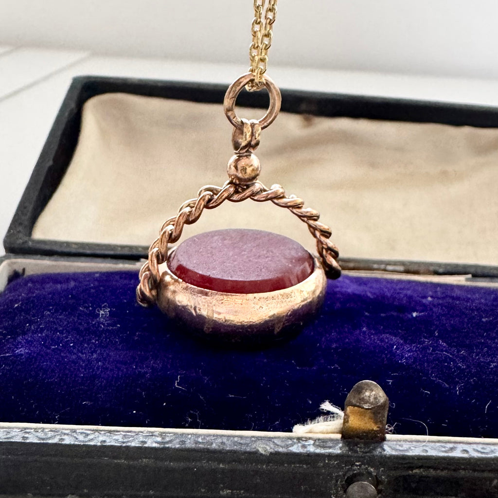 Antique rolled gold carnelian and bloodstone spinning fob on a vintage jewellery box
