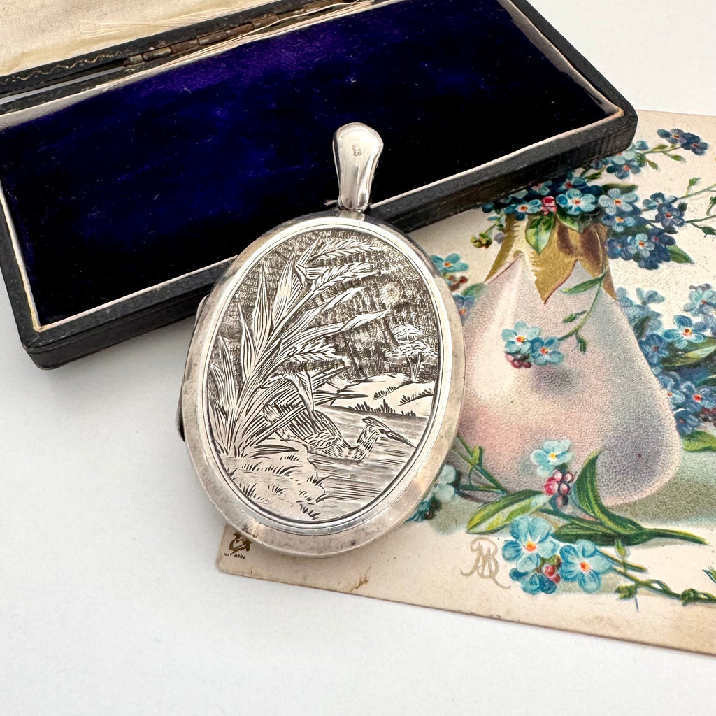 Antique 1879 sterling silver locket with engraved design in a box with floral card