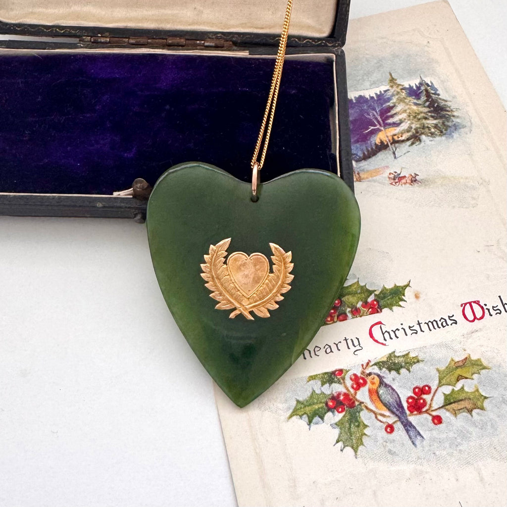 Large New Zealand greenstone and 9ct gold heart pendant on an old jewellery box and with a vintage Christmas card