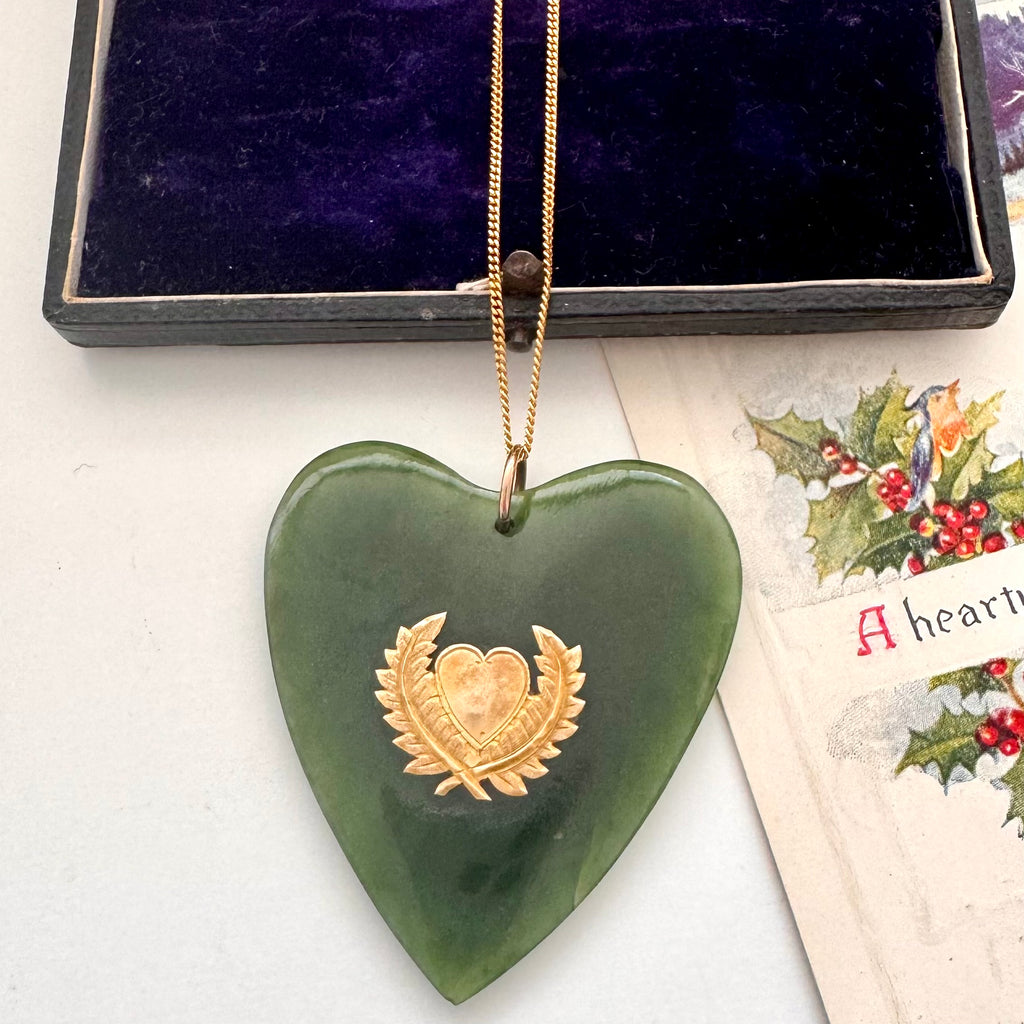 Large New Zealand greenstone and 9ct gold heart pendant on an old jewellery box and with a vintage Christmas card