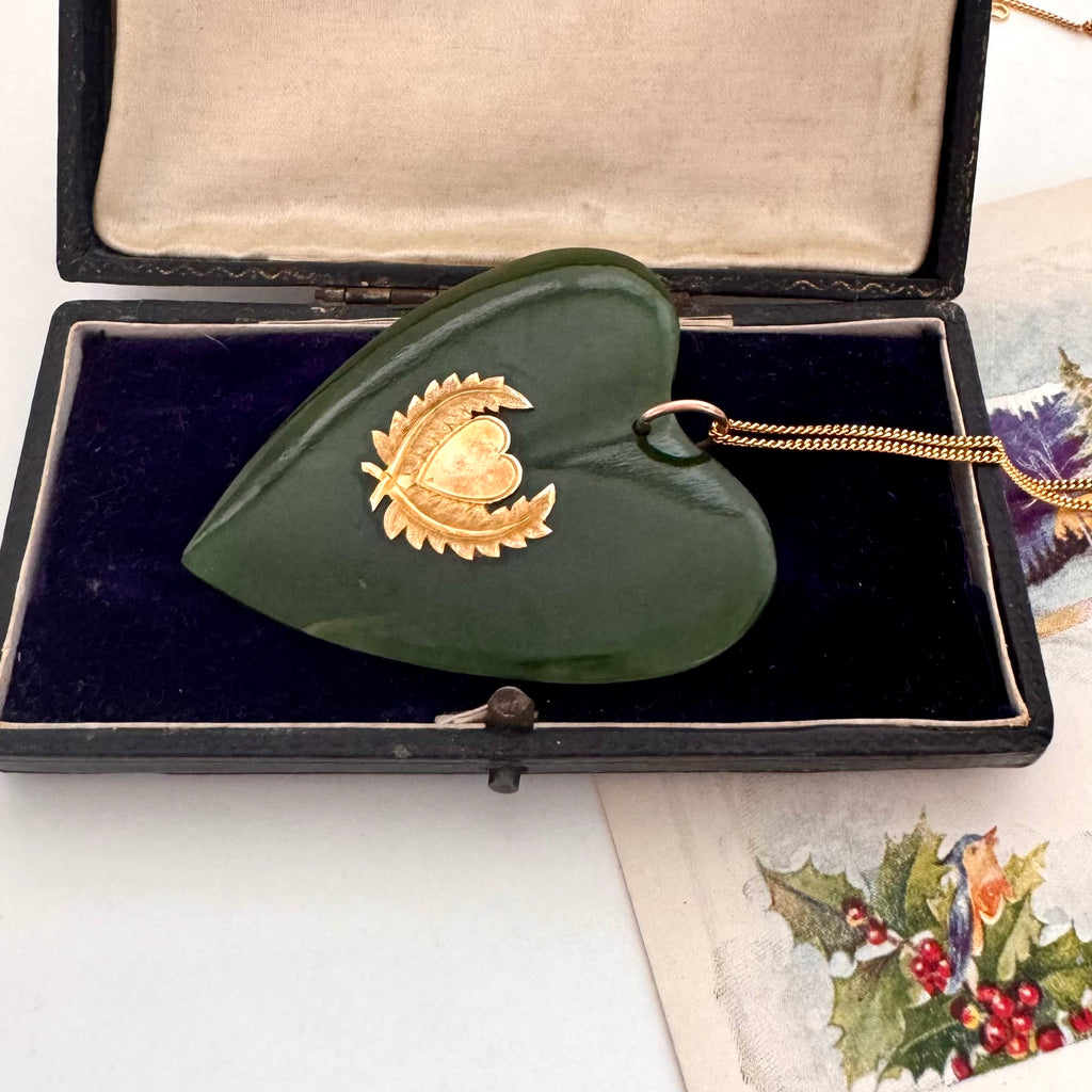 Large New Zealand greenstone and 9ct gold heart pendant on an old jewellery box and with a vintage Christmas card