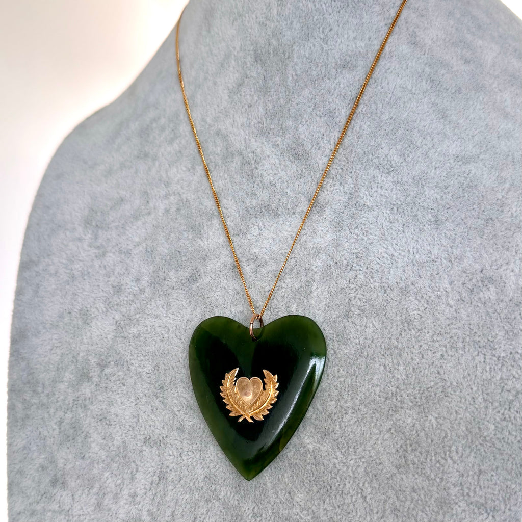 Large New Zealand greenstone and 9ct gold heart pendant on a grey mannequin