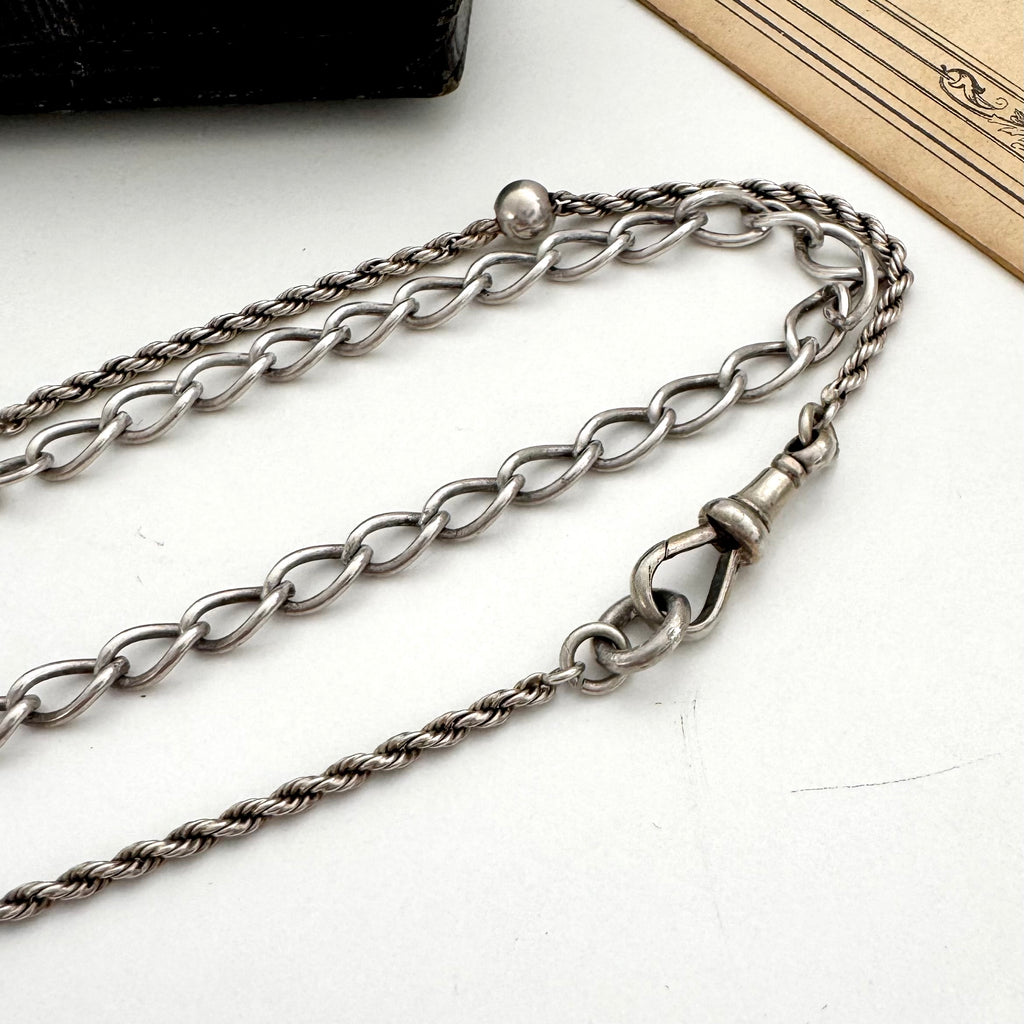 Silver chain necklace on a white surface