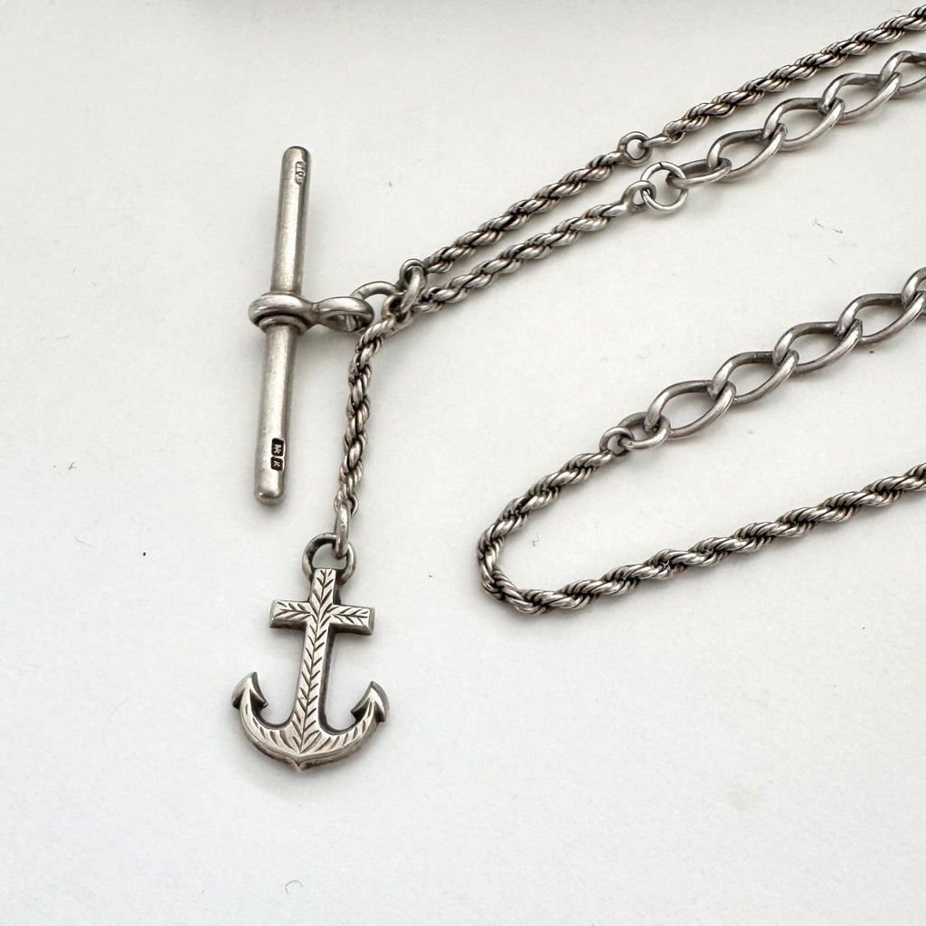 Silver necklace with an anchor pendant on a white background