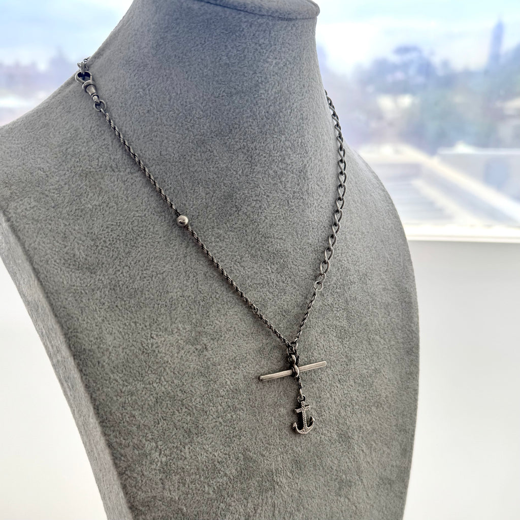 Antique silver albertina chain necklace with an anchor pendant on a grey mannequin