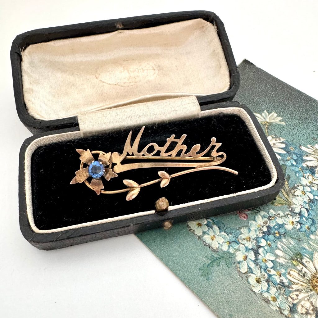 Vintage Mother brooch with a blue stone in an old jewellery box