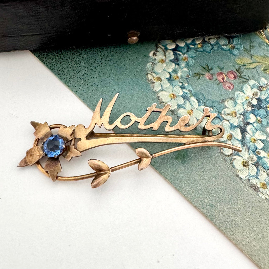 Vintage Mother brooch on an old postcard