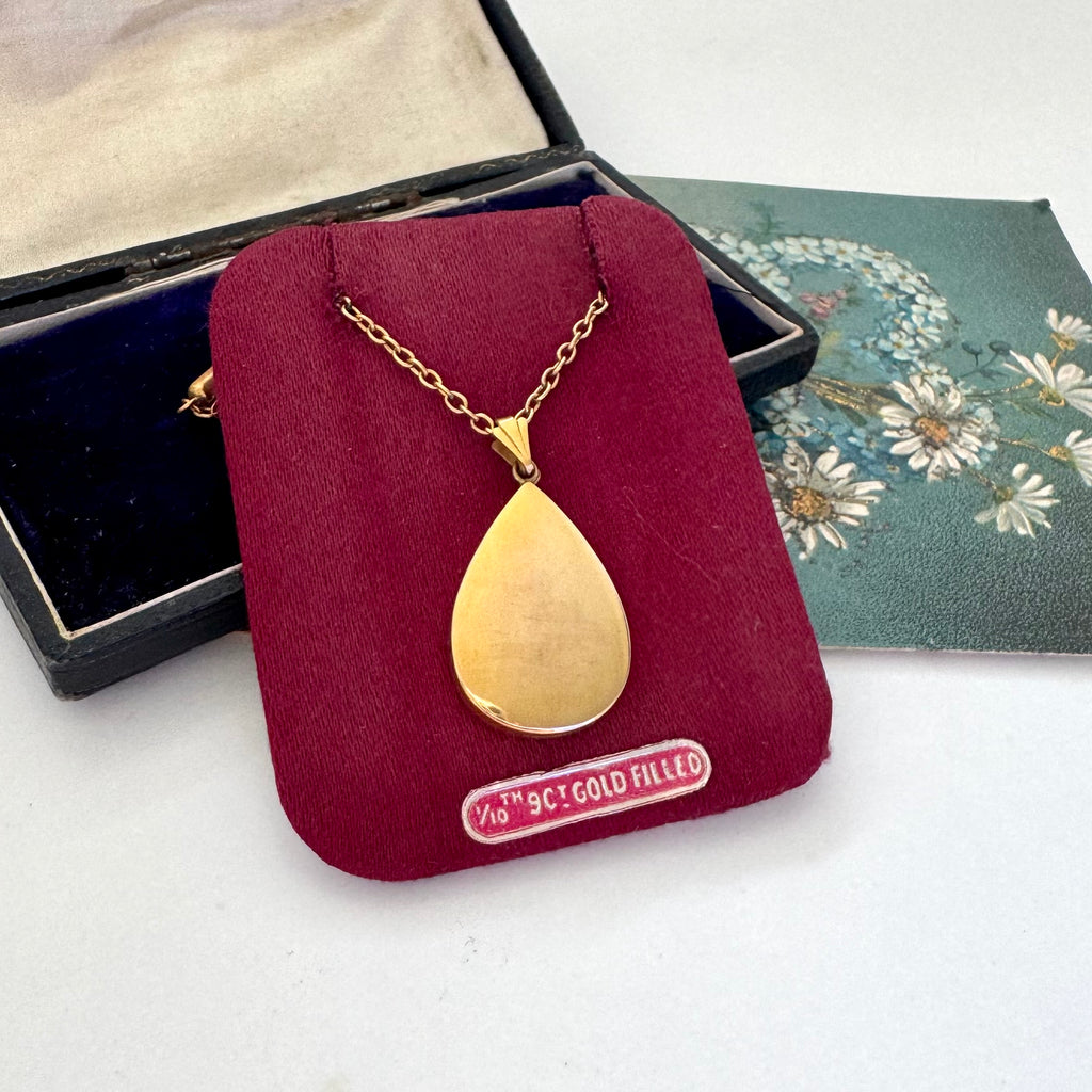 Vintage Handley Australian mid century gold fill teardrop pendant necklace on its original presentation card and a floral card with a jewelry box in the background