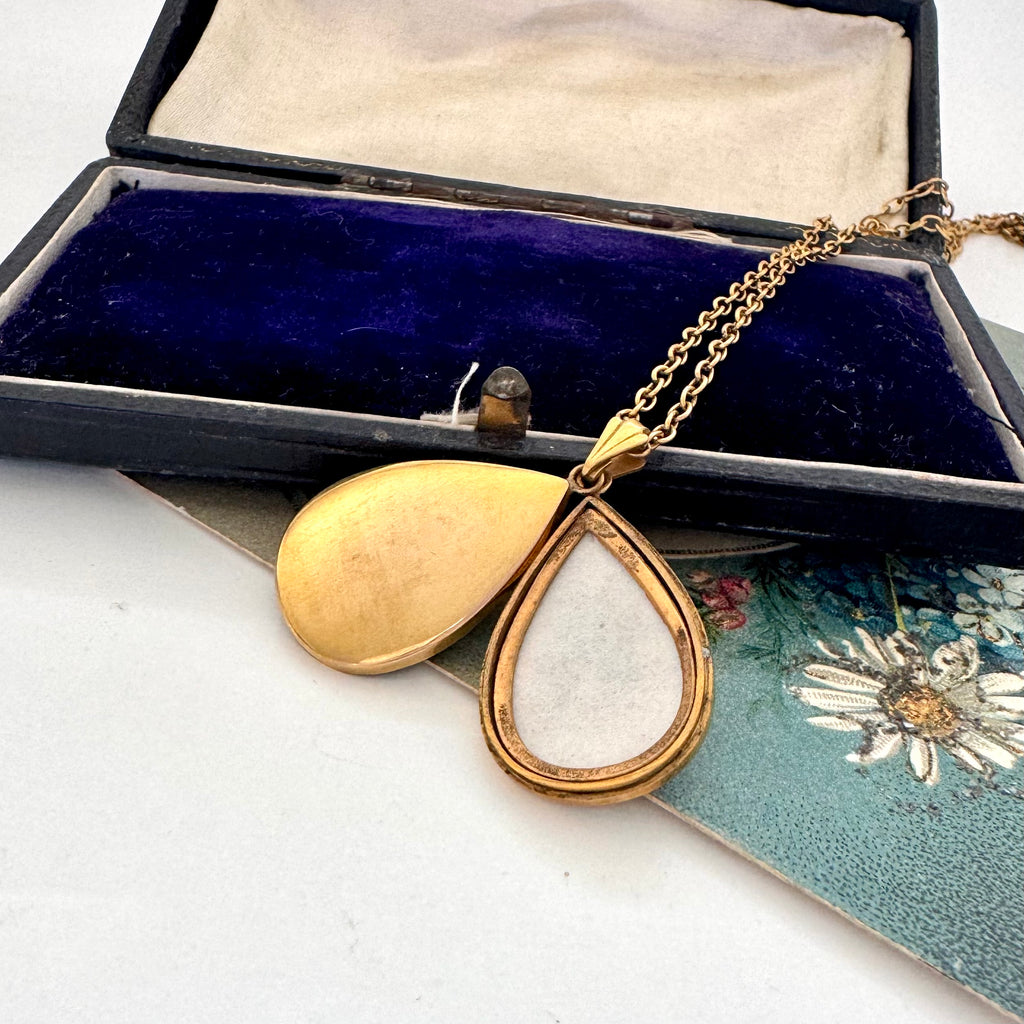 Vintage Handley Australian mid century gold fill teardrop pendant necklace on a floral card with a jewelry box in the background