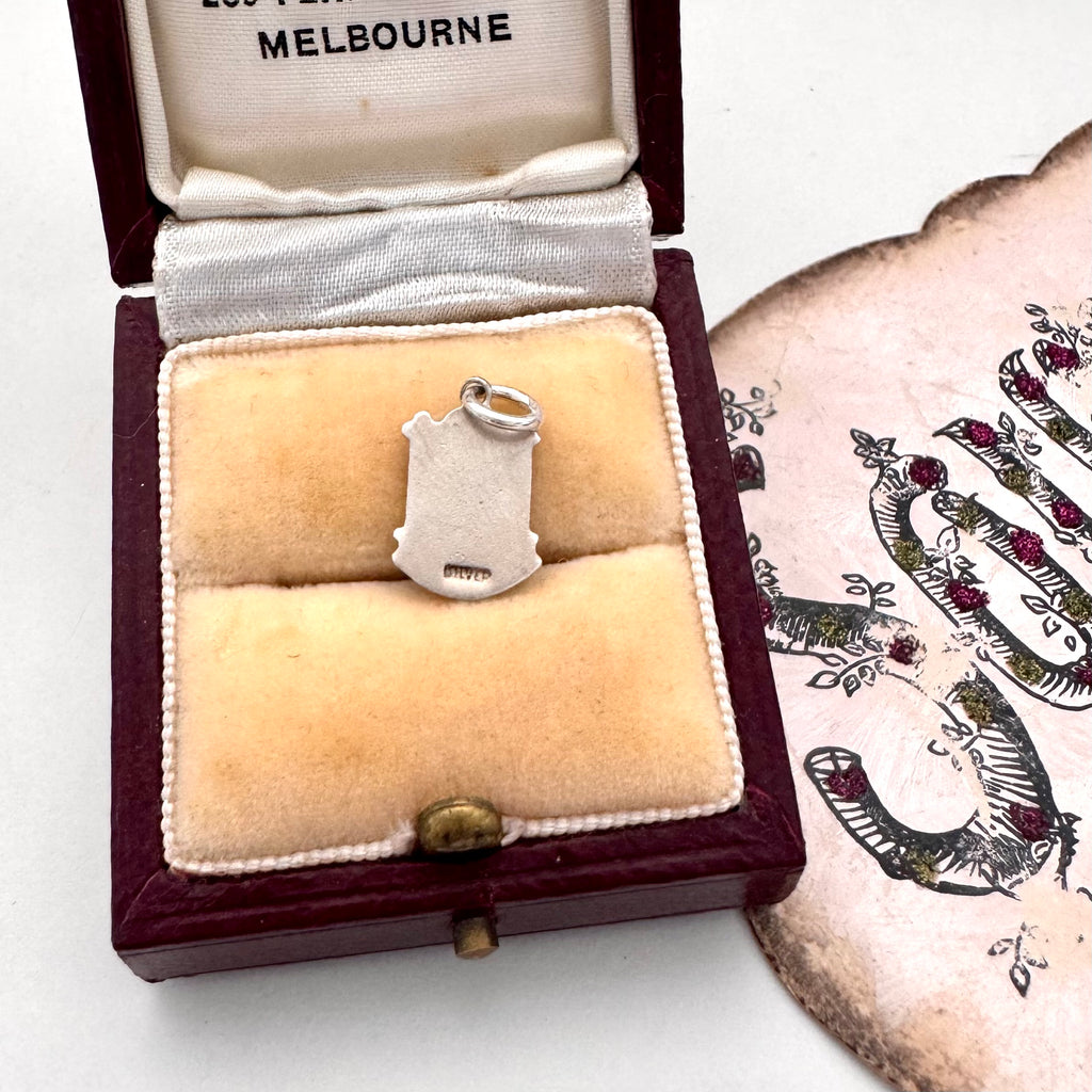 Vintage silver Eastbourne travel charm on a jewellery box