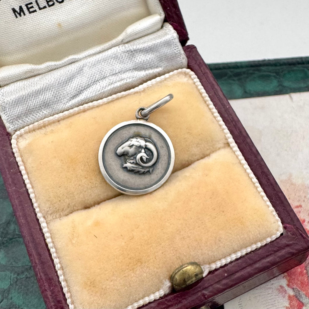 Vintage Uno A Erre silver Aries charm on an old jewellery box