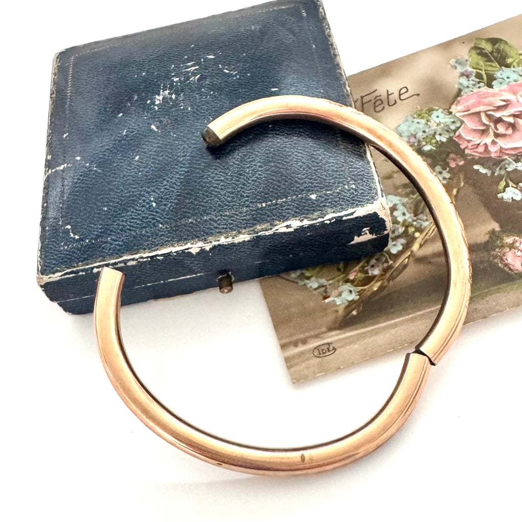 Antique gold fill bracelet on an old box with a white background