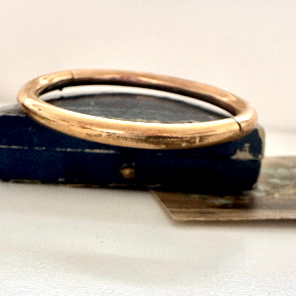 Antique gold fill bracelet on an old box with a white background