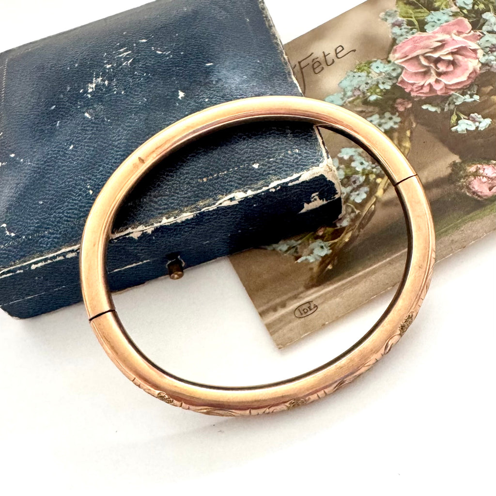 Antique gold fill bracelet on an old box with a white background