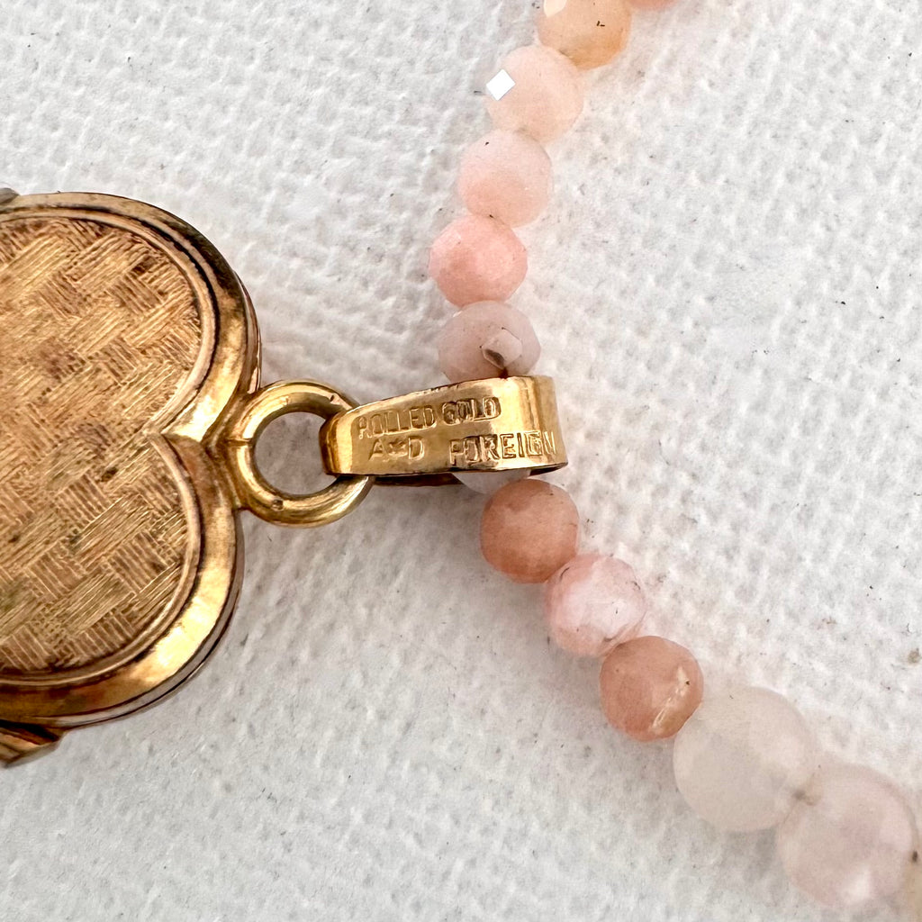 Close up of gold heart locket bail